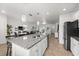 Open-concept kitchen featuring granite countertops, stainless steel appliances, and bar seating at 16162 Arbor Crest Aly, Winter Garden, FL 34787