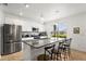 Well-lit kitchen with stainless steel appliances, granite countertops, and a kitchen island at 16162 Arbor Crest Aly, Winter Garden, FL 34787