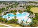 Aerial view of a resort-style pool area surrounded by palm trees and comfortable lounge chairs at 16162 Arbor Crest Aly, Winter Garden, FL 34787