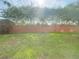 View of backyard through the screens of the lanai at 1625 Priory Cir, Winter Garden, FL 34787