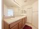 Bathroom featuring double sink vanity and closet doors at 1625 Priory Cir, Winter Garden, FL 34787