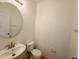 Half bathroom with a round mirror, standard toilet, and a pedestal sink at 1625 Priory Cir, Winter Garden, FL 34787