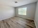 Bedroom with modern flooring, a window with blinds, and neutral paint offering a calming space at 1625 Priory Cir, Winter Garden, FL 34787