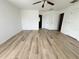 Bedroom featuring wood floors, a ceiling fan, and doors to closet and bathroom at 1625 Priory Cir, Winter Garden, FL 34787
