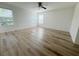 Bedroom featuring wood floors, a ceiling fan, and three windows at 1625 Priory Cir, Winter Garden, FL 34787