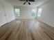 Bedroom featuring wood floors, a ceiling fan, and three windows at 1625 Priory Cir, Winter Garden, FL 34787