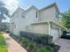 Inviting home exterior with a brick walkway and meticulously landscaped greenery, creating a serene atmosphere at 1625 Priory Cir, Winter Garden, FL 34787