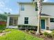 Backyard view of the home featuring a screened-in patio and well-maintained lawn surrounded by lush landscaping at 1625 Priory Cir, Winter Garden, FL 34787