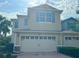 Charming home featuring a two-car garage, well-maintained landscaping, and inviting curb appeal at 1625 Priory Cir, Winter Garden, FL 34787