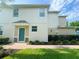 Welcoming front entrance with a teal door, stone accents, and neat landscaping, offering great curb appeal at 1625 Priory Cir, Winter Garden, FL 34787