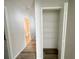 Hallway with wood floors leading to a bathroom and linen closet at 1625 Priory Cir, Winter Garden, FL 34787