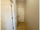 Hallway with neutral paint, tiled floor, and doors, offering access to other rooms at 1625 Priory Cir, Winter Garden, FL 34787