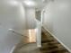 Hallway with wood-look flooring and neutral paint, connecting different areas of the upper level at 1625 Priory Cir, Winter Garden, FL 34787