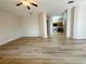 Bright, open living room with modern flooring, neutral paint, and a ceiling fan for comfortable living at 1625 Priory Cir, Winter Garden, FL 34787