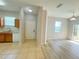 An open-concept living room featuring stylish wood flooring, tile flooring in the kitchen and lots of natural light at 1625 Priory Cir, Winter Garden, FL 34787