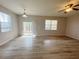 Spacious living room with light-colored wood flooring and a ceiling fan at 1625 Priory Cir, Winter Garden, FL 34787