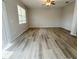 Bright living room with wood-look flooring, neutral walls, and natural light at 1625 Priory Cir, Winter Garden, FL 34787