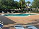 Community pool area features brick pavers and lounge chairs for resident's relaxation and enjoyment at 1625 Priory Cir, Winter Garden, FL 34787
