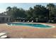Community pool with brick deck, lounge chairs, and fencing for relaxation and safety at 1625 Priory Cir, Winter Garden, FL 34787