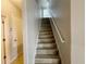 Staircase with wood-look steps and white handrail, leading to the upper level of the home at 1625 Priory Cir, Winter Garden, FL 34787
