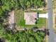 Aerial view of the property highlighting the home's layout, green surroundings, and nearby road at 16253 Sw 29Th Court Rd, Ocala, FL 34473