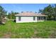 Rear exterior view of home with ample backyard space and lush greenery at 16253 Sw 29Th Court Rd, Ocala, FL 34473