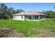Home exterior with a covered patio and views of the green backyard at 16253 Sw 29Th Court Rd, Ocala, FL 34473