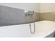 Close up of modern soaking tub featuring chrome shower head at 16253 Sw 29Th Court Rd, Ocala, FL 34473