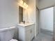 Bathroom featuring a toilet, modern vanity with lighting, and a doorway leading to another room at 16253 Sw 29Th Court Rd, Ocala, FL 34473