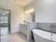 Bright bathroom with modern soaking tub, vanity, and stylish finishes at 16253 Sw 29Th Court Rd, Ocala, FL 34473