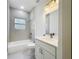 Bathroom featuring a shower-tub combo and a sleek vanity with modern fixtures at 16253 Sw 29Th Court Rd, Ocala, FL 34473