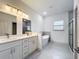 Bright bathroom features double vanity, soaking tub, glass shower, and modern fixtures at 16253 Sw 29Th Court Rd, Ocala, FL 34473