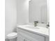 Modern bathroom with a white vanity, a speckled countertop, and a large mirror at 16253 Sw 29Th Court Rd, Ocala, FL 34473