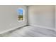 Cozy bedroom featuring neutral walls, modern flooring, and a sunlit window at 16253 Sw 29Th Court Rd, Ocala, FL 34473