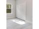Bright bedroom showcasing modern flooring, neutral walls, and a window view near a large closet at 16253 Sw 29Th Court Rd, Ocala, FL 34473