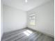 Bright bedroom with gray wood floors and natural light from a large window at 16253 Sw 29Th Court Rd, Ocala, FL 34473