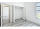 A bright bedroom with closet storage and a neutral color palette, providing a serene atmosphere at 16253 Sw 29Th Court Rd, Ocala, FL 34473