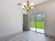 Dining room features modern chandelier and sliding glass door to patio at 16253 Sw 29Th Court Rd, Ocala, FL 34473
