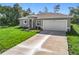 Single Gathering home in a wooded area featuring a two car garage and lovely landscaping at 16253 Sw 29Th Court Rd, Ocala, FL 34473