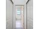 Hallway view leading to a well-lit room with neutral colors, featuring closet storage at 16253 Sw 29Th Court Rd, Ocala, FL 34473