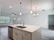 Modern kitchen island with a stainless dishwasher, sink, and cabinets with quartz countertops at 16253 Sw 29Th Court Rd, Ocala, FL 34473