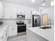 Bright kitchen with white cabinetry, stainless steel appliances, and quartz countertops at 16253 Sw 29Th Court Rd, Ocala, FL 34473