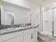 Bright bathroom featuring granite counters, single sink, toilet, and glass enclosed shower with tile surround at 1632 Tropical Palms Circle, Kissimmee, FL 34747