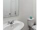 Clean and simple bathroom with a toilet, sink, and a mirror at 1632 Tropical Palms Circle, Kissimmee, FL 34747