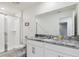 Well-lit bathroom featuring a shower, toilet, vanity with granite countertop, and modern fixtures at 1632 Tropical Palms Circle, Kissimmee, FL 34747