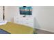 Bedroom showing dresser with TV, complemented by green bedding, and modern decor at 1632 Tropical Palms Circle, Kissimmee, FL 34747