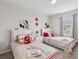 Bright bedroom featuring two twin beds, playful decor, and plenty of natural light at 1632 Tropical Palms Circle, Kissimmee, FL 34747