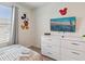Bedroom featuring dresser with TV, complemented by Mickey Mouse decor, and striped bedding at 1632 Tropical Palms Circle, Kissimmee, FL 34747