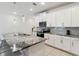 Well-lit kitchen with white cabinetry, granite counters, and stainless steel appliances at 1632 Tropical Palms Circle, Kissimmee, FL 34747