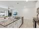 Bright kitchen with granite counters, stainless steel appliances, and pendant lighting at 1632 Tropical Palms Circle, Kissimmee, FL 34747